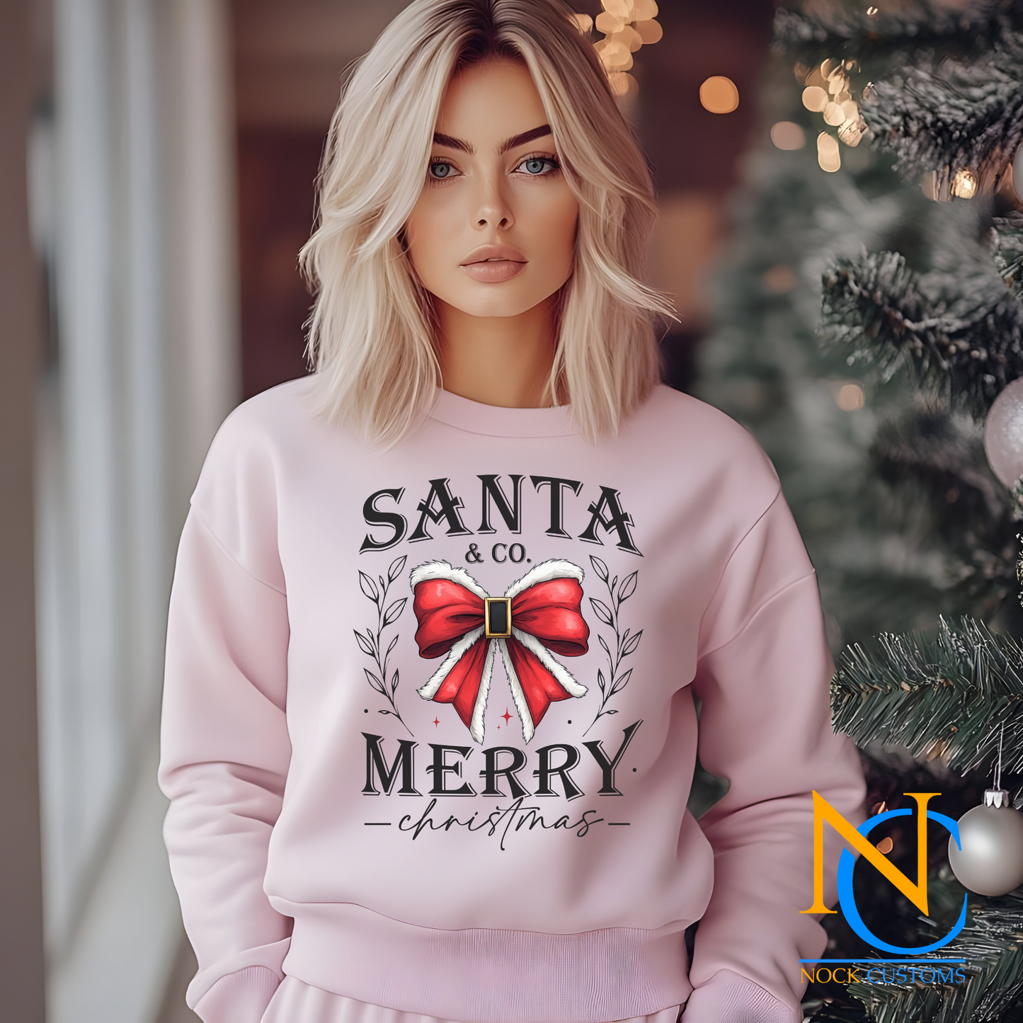 Santa & Co. Merry Christmas transfer featuring a classic red holiday bow with decorative leaves.