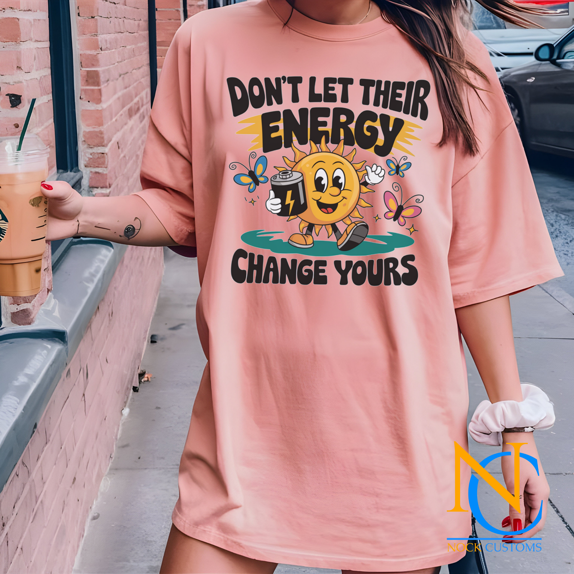 A cheerful design featuring a smiling sun holding a battery, surrounded by colorful butterflies and the text 'Don't Let Their Energy Change Yours.' Perfect for direct-to-film (DTF) transfers with a motivational and uplifting vibe.