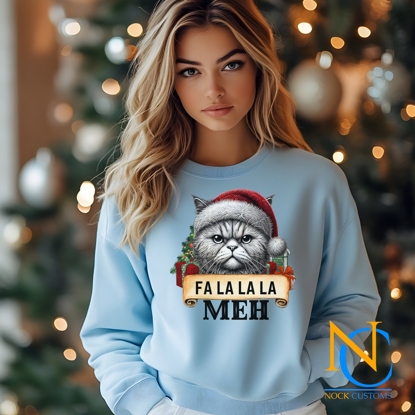Close-up of a cat-themed holiday design on a hoodie, featuring 'Fa La La La Meh' in festive lettering.