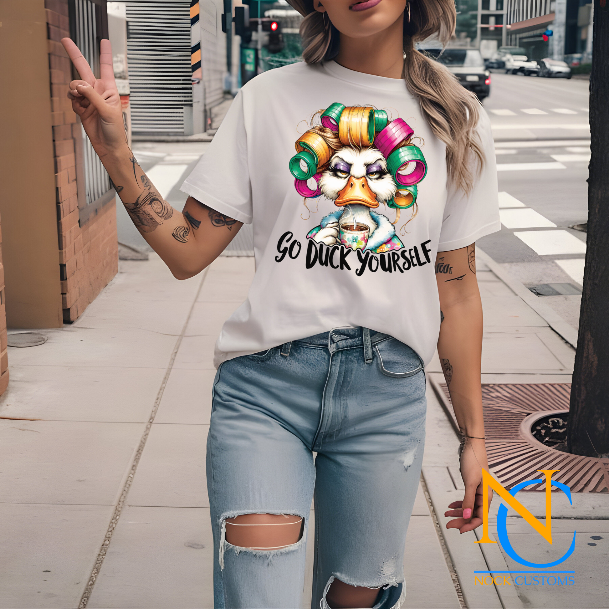 A humorous and sassy design featuring a duck with colorful hair rollers, a tired expression, holding a coffee cup, with the text 'Go Duck Yourself.' Perfect for direct-to-film (DTF) transfers with a bold and funny vibe.