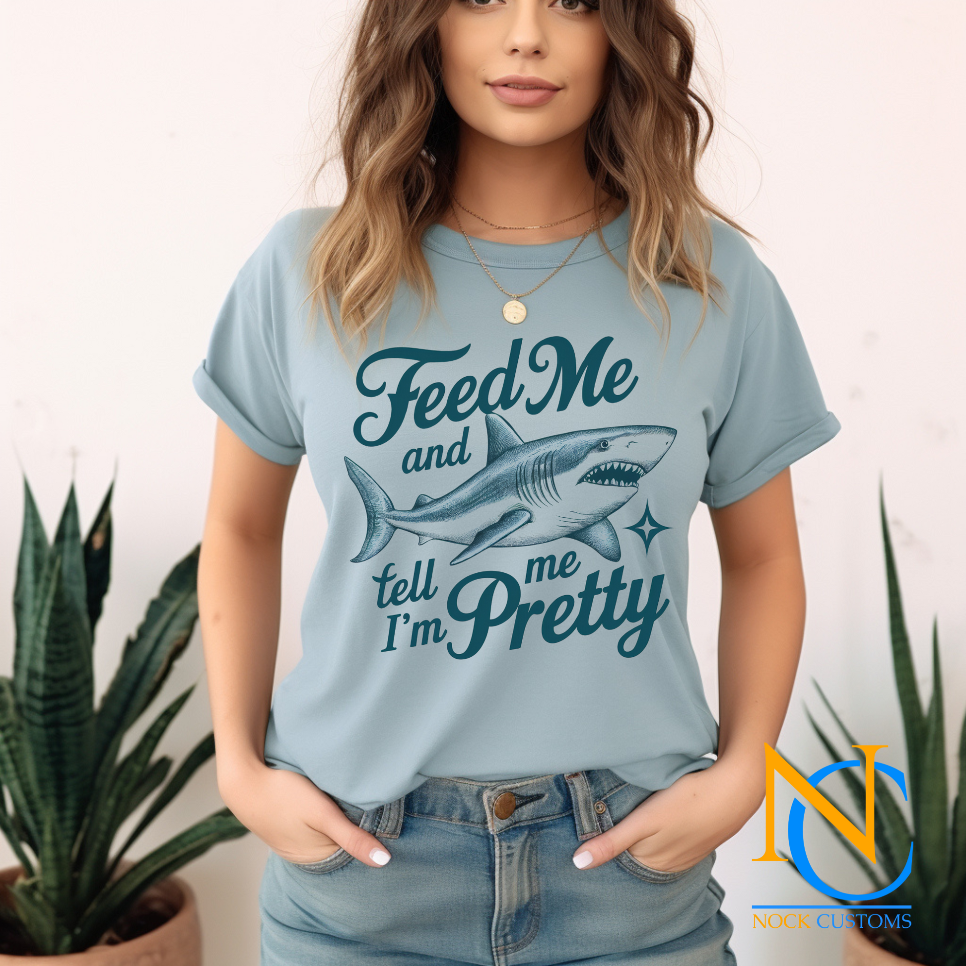 A playful design featuring a fierce shark with the humorous text 'Feed Me and Tell Me I'm Pretty,' complemented by a sparkling star accent. Perfect for direct-to-film (DTF) transfers with a fun and quirky vibe.