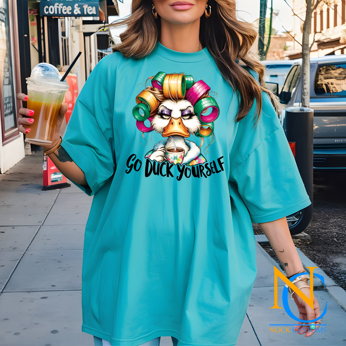 A humorous and sassy design featuring a duck with colorful hair rollers, a tired expression, holding a coffee cup, with the text 'Go Duck Yourself.' Perfect for direct-to-film (DTF) transfers with a bold and funny vibe.