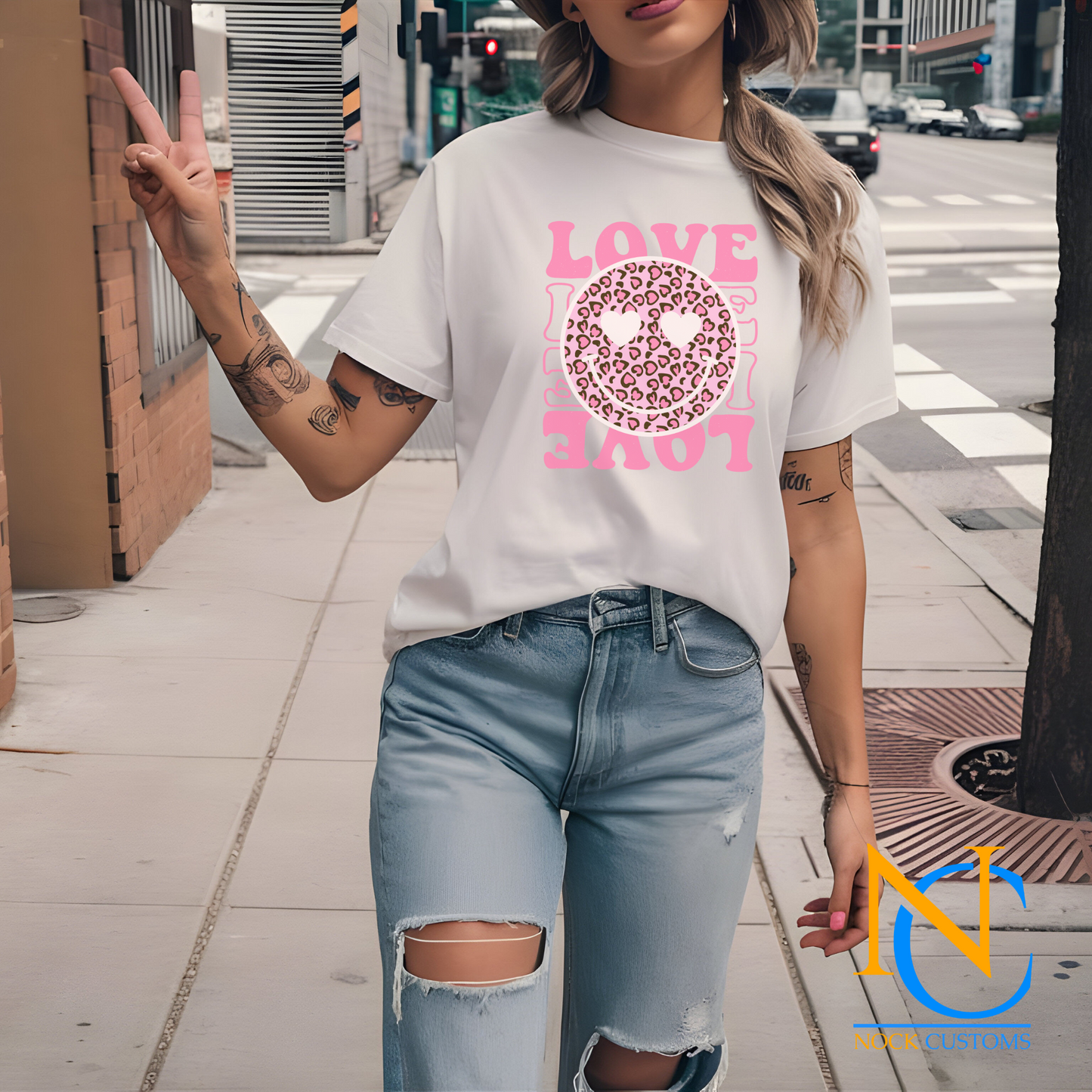 A vibrant pink design featuring a leopard print smiley face with heart eyes, surrounded by the word 'LOVE' in bold pink letters. Perfect for direct-to-film (DTF) transfers on various materials.