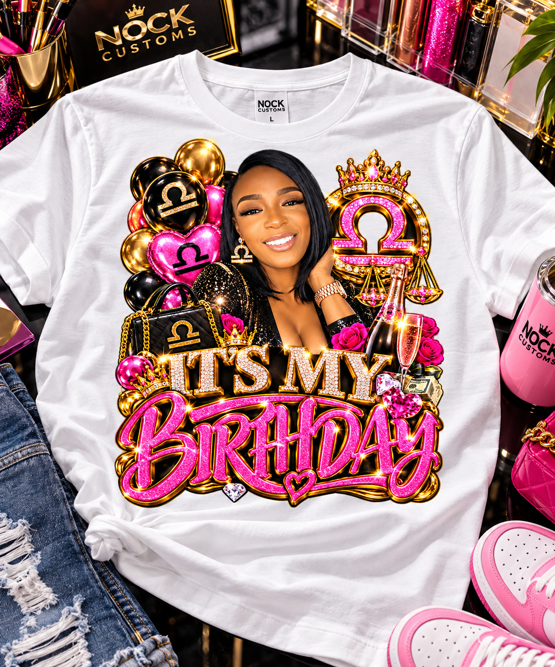 White Libra birthday T-shirt laid flat with crowned zodiac artwork, balloons, roses, and pink-and-gold birthday lettering.