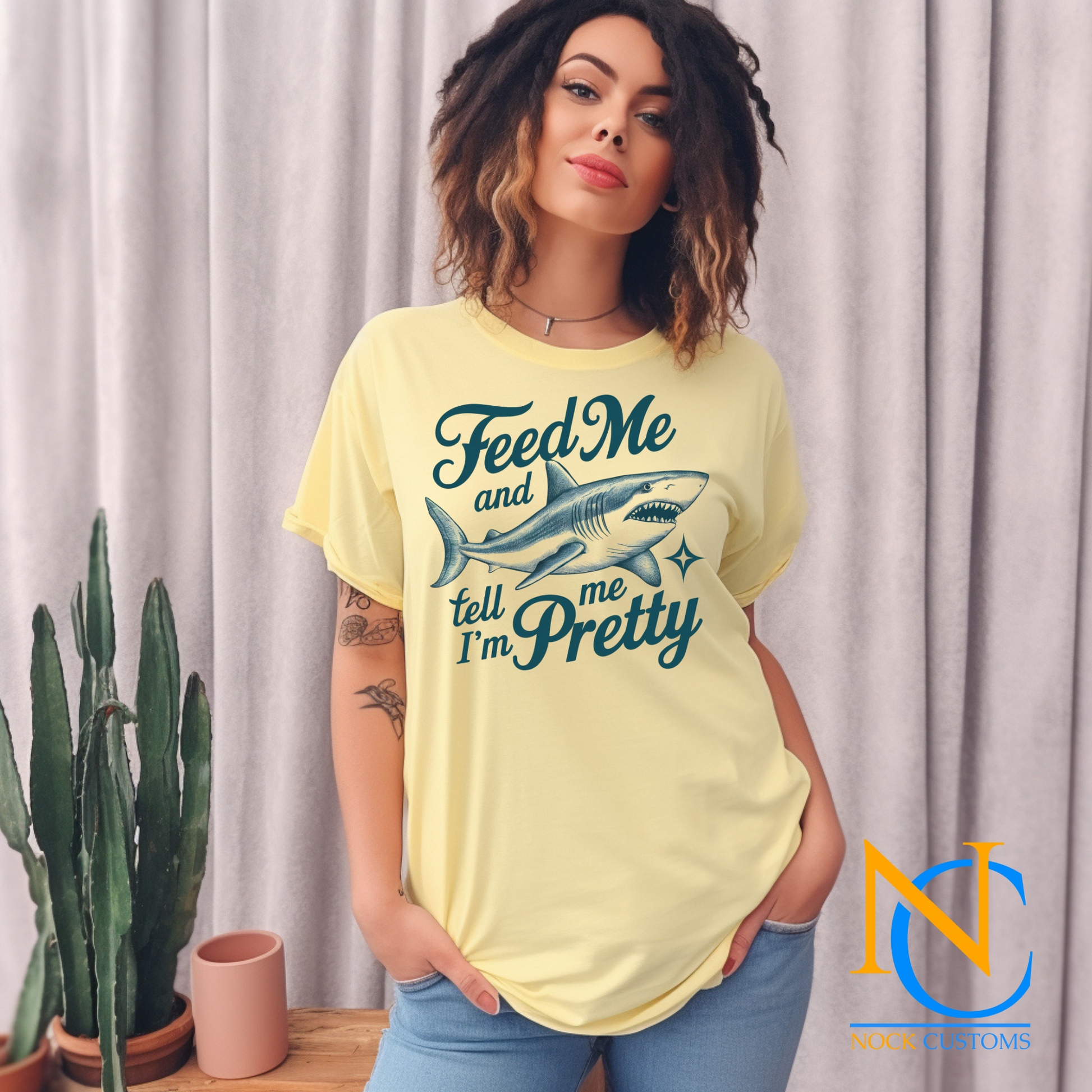 A playful design featuring a fierce shark with the humorous text 'Feed Me and Tell Me I'm Pretty,' complemented by a sparkling star accent. Perfect for direct-to-film (DTF) transfers with a fun and quirky vibe.