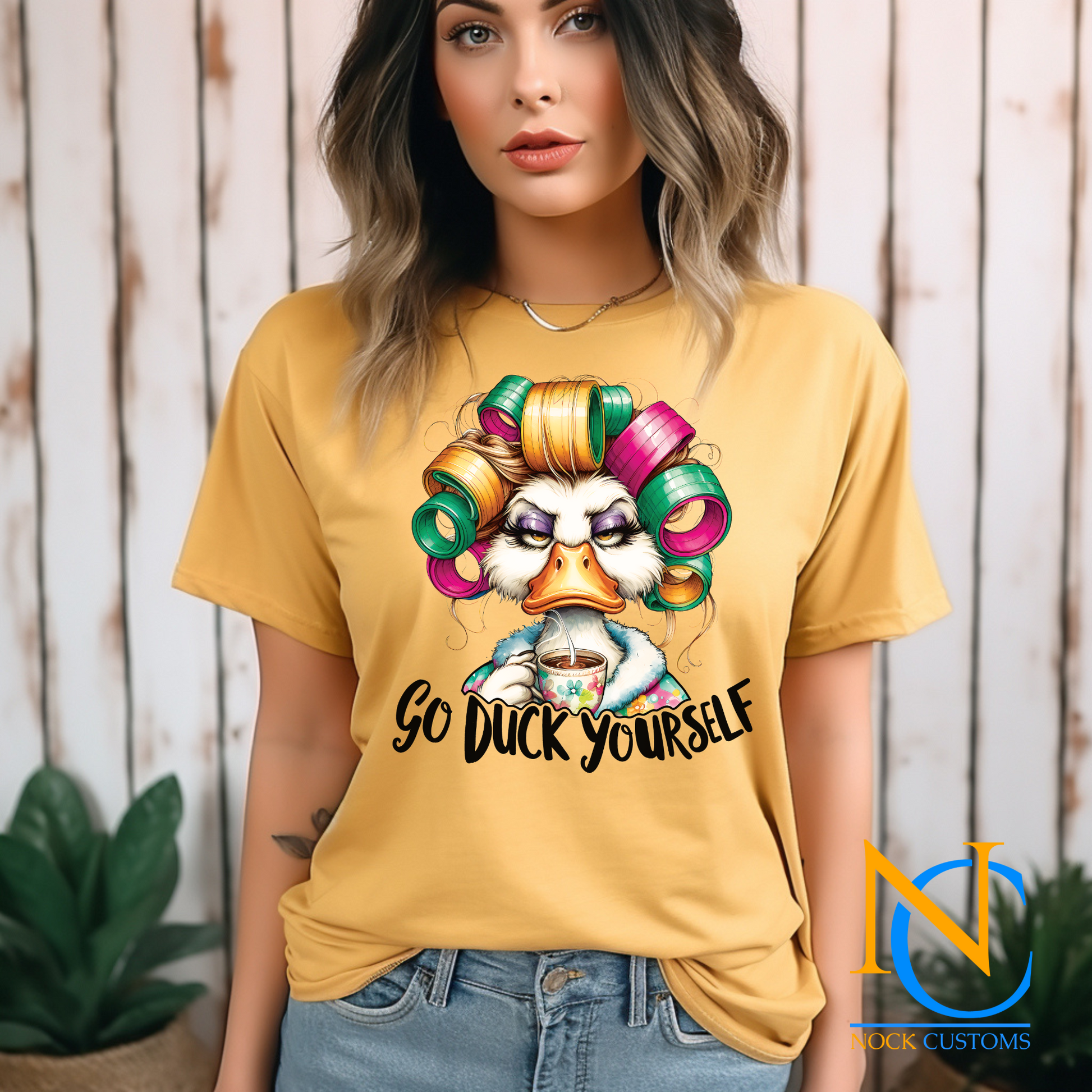 A humorous and sassy design featuring a duck with colorful hair rollers, a tired expression, holding a coffee cup, with the text 'Go Duck Yourself.' Perfect for direct-to-film (DTF) transfers with a bold and funny vibe.